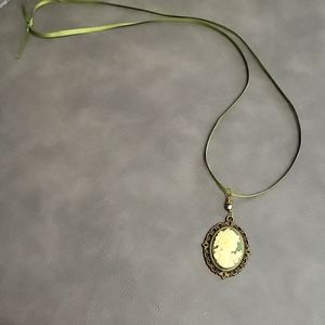 Beautiful hunter Green Cameo necklace with bronze backing and luxurious design